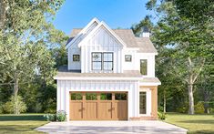 a white house with two brown garage doors on the front and one story above it