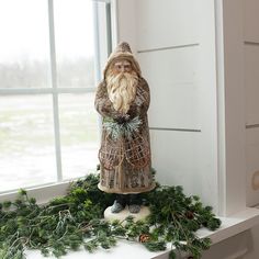 a gnome statue sitting on top of a window sill