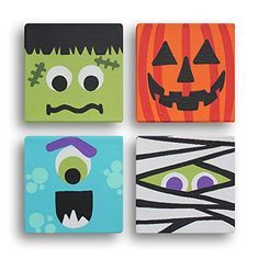 four halloween canvases with different faces and designs on the front, one in orange, one in green