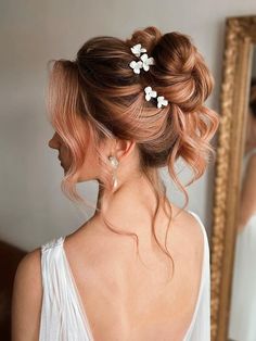 a woman with blonde hair and flowers in her hair is looking at herself in the mirror