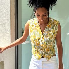 A fresh c.1990s vintage waistcoat by Salvatore Ferragamo, in summery yellow and green floral print fine wool.  V neck, with gold tone buttons, cropped to the waist. Material:  wool Size: EU42 UK10 Measurements (laid flat): Shoulder to shoulder:  36cm Bust: 92cm Length: 50cm Condition: excellent Retro V-neck Vest For Spring, Spring Floral Print V-neck Vest, Cropped Vest With Button Closure For Summer, Vintage V-neck Vest For Spring, Fitted Summer Vest With Buttons, Cropped Summer Vest With Buttons, Summer Cropped Vest With Buttons, Yellow V-neck Vest For Spring, Retro V-neck Spring Vest