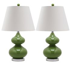 two green lamps sitting next to each other on top of a white table lamp shade