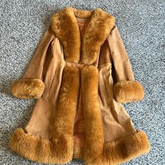 70’s Vintage Rear Suede Shearling Boho Hippy Coachella Princess Fit And Flare Tie Waist Side Pocket Small Marks On The Leather In A Few Spots See Photo 9,10 But No Thinning Or Holes, Great Vintage Condition Overall. Fur Trim There Is A Tag In It That Says Size 16 But That's Definitely Not Accurate With Today's Sizing, I Would Say It Fits Like A M Check Measurements Soft Suede In Camel Color Excellent Condition Fit And Flare Shape Soft Shearling Vintage, 70’s 80’s Measurements Armpit To Armpit 21” Waist 19” Length 41” I Don’t Know If The Fur Is Real Or Not, No Tag. This Coat Weight About 2 To 3 Pounds Is In Excellent Condition 80s Fur Coat, Fitted Vintage Sheepskin Fur Coat, Penny Lane Fur Coat, Luxury Vintage Shearling Fur Coat, Vintage Brown Sheepskin Outerwear, Brown Vintage Fur Coat With Faux Fur Trim, Fur Trim Coat, Princess Coat, Draping Fashion