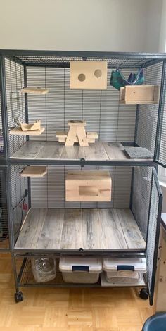 a large bird cage with shelves and drawers