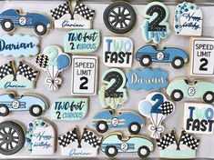 decorated cookies in the shape of cars and numbers