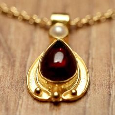 Garnets, hand cut au cabochon, cast their rosy glow over all passersby. 14k gold settings; with cultured pearl accents. Comes on 14" chain. Star Garnet, Ruby Engagement Ring, Garnet Necklace, Rhodolite Garnet, Moonstone Necklace, Fantasy Jewelry, Hand Made Jewelry, Gorgeous Necklaces, Beautiful Necklaces