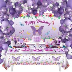 a birthday party with purple balloons and decorations