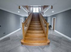 an empty room with stairs leading up to the second floor