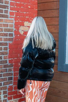 Embrace a bold and contemporary look with this ultra-puffy, high-gloss faux leather jacket in classic black. The high-gloss finish adds a sleek and edgy vibe, while the ultra-puffy design ensures both warmth and style in colder weather. The inclusion of a hood adds an element of practicality, providing extra protection from the elements while maintaining your fashion-forward aesthetic. Whether you're heading out for a night on the town or simply want to make a statement, this jacket effortlessly Trendy Fitted Shiny Outerwear, Chic Shiny Outerwear For Fall, Cold Weather Faux Leather Puffer Outerwear, Trendy Black Puffer Leather Jacket, Luxury Black Modern Puffer Jacket, Glossy Puffer Jacket, Leather Puffer Jacket With Padded Collar, Luxury Black Leather Puffer Jacket, Puffy Design