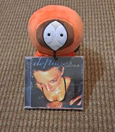 a stuffed animal with an album on it