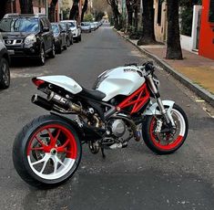 a white and red motorcycle parked on the street