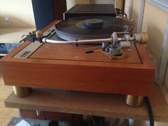 a record player sitting on top of a wooden table