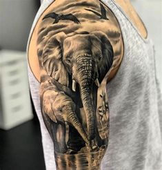 an elephant and birds tattoo on the arm