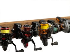 several different types of fishing reels are lined up