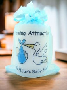 a baby shower bag with a stork on it and a blue ribbon around the top