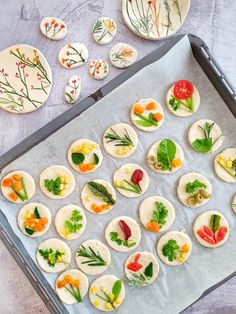 small appetizers are arranged on a baking sheet and ready to go into the oven