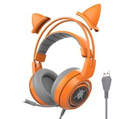 an orange gaming headset with two ears on the side and a charger plugged in