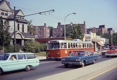 cars and buses are driving down the street