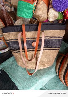 You don't have to be a millionaire to elevate your style and fashion, you need creativity and Arts. We African 1 Stores offers to you the most modern hand made tote bag woven 100% from sisal with Quality leather straps locally tunned from cows.  These beautiful handmade Tote bag originated from craftsmen living in Eastern Community in Kenya, the Akamba. Our Tote bags are woven using colored sisal and leather.The woven bag is made from products which are entirely eco-friendly and sustainable, leather to provide comfort and padding. Leathers are naturally tanned from cows. It has a zipper and an inner lining. This Tote bag is really stylish, functional and eco-friendly for everyday use, summer travels and beyond. From travel to work or a night out, makes it easier to fill your closet with et Handwoven Beach Shoulder Bag For Travel, Handwoven Shoulder Beach Bag For Travel, Handwoven Basket Beach Bag For Travel, Black Straw Bag For Market, Travel Beach Bag, Handwoven Jute, Basket Shoulder Bag In Natural Fiber For Travel, Handmade Black Beach Bag With Natural Fiber, Handwoven Straw Shoulder Bag For Travel, Handwoven Jute Beach Bag For Travel