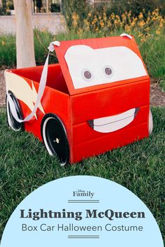 a box shaped like a car sitting in the grass with text overlay reading lightning mcquen box halloween costume