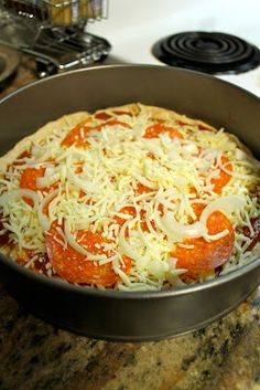 a pizza sitting in a pan on top of a stove