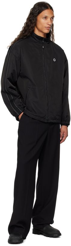 Insulated nylon- and polyester-blend satin jacket. · Stand collar · Two-way zip closure · Rubberized logo patch at chest · Zip pockets · Concealed bungee-style drawstring at hem · Webbing trim at sleeves · Elasticized cuffs · Patch pocket at interior · Full quilted satin lining Supplier color: Black Urban Nylon Track Jacket With Zip Cuffs, Streetwear Nylon Windbreaker With Zip Cuffs, Urban Nylon Track Jacket With Zipper Closure, Techwear Nylon Windbreaker With Zip Cuffs, Nylon Windbreaker With Zip Fly For Streetwear, Sporty Nylon Track Jacket With Zip Cuffs, Black Nylon Track Jacket With Zipper, Technical Nylon Track Jacket With Reflective Details, Nylon Techwear Track Jacket With Ykk Zipper