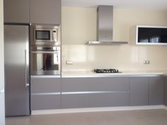 a modern kitchen with stainless steel appliances and cabinets