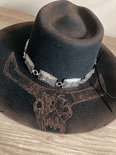 *Size: Medium 6 3/4 - 6 7/8 *Black felt Charlie1horse Highway style hat *Burned & distressed  *Bull skull burned on the brim *Large silver concho hat band with black leather ties Vintage Felt Hat With Flat Crown For Ranch, Vintage Flat Crown Felt Hat For Ranch, Western Felt Hat With Flat Crown For Western-themed Events, Vintage Flat Crown Top Hat For Rodeo, Western Hat Bands With Flat Crown For Rodeo, Western Style Hat Bands With Flat Crown For Rodeo, Silver Brimmed Hat For Rodeo, Silver Hat With Curved Brim For Rodeo, Black Rustic Hat For Rodeo