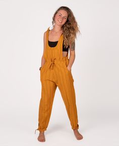 Take up the beauty of any new adventure in these unique hippie overalls! Designed with a striped pattern, cotton fabric, and a tie string to keep you snug. Features multiple pockets in the front, on the sides, and in the back- you can hold your most cherished belongings without trouble. These are true boho overalls with tie-on and ankle adjustments - adjust as you please! Add a Soul Flower cropped tank under these overalls for some cute, hippie vibes! Ethically made in Nepal. 100% cotton. Pineap