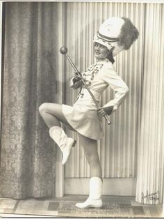 an old black and white photo of a woman in uniform