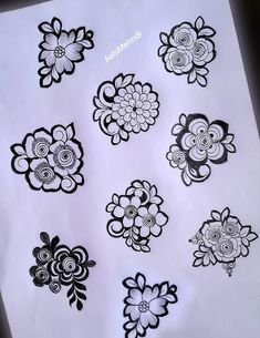 an assortment of black and white flowers on a sheet of paper