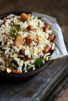 a bowl filled with rice and nuts on top of a tray