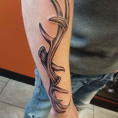 a man with a tattoo on his arm has a deer's antelope