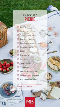 a picnic table with food and drinks on it, including cheeses, crackers, strawberries