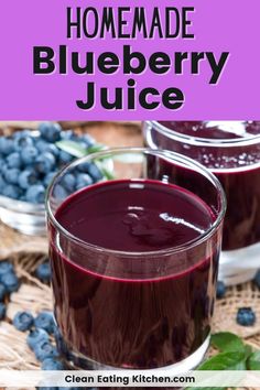 two glasses filled with blueberry juice sitting on top of a table next to fresh blueberries