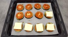 tomatoes and cheese on a tray ready to go in the oven