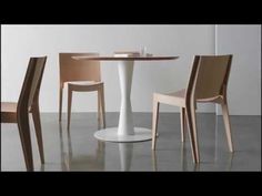 a table with four chairs around it and a white plate on the table next to it