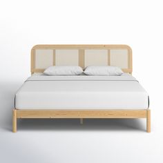 the bed is made up with white sheets and wooden headboard, along with pillows