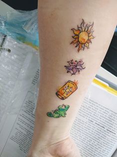 a person with a tattoo on their arm and foot that has pictures of different things on it