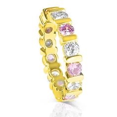 a yellow gold ring with pink and white stones