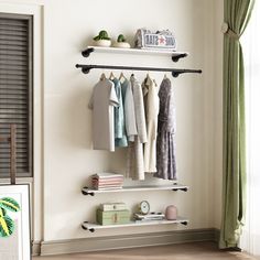 there is a shelf with clothes on it in the room next to a door and window