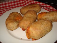 some fried food on a white plate with a red and white checkered table cloth