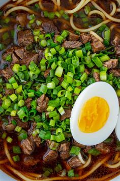 an egg and meat soup with noodles in a bowl