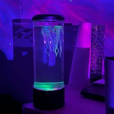 a purple and blue light shines on a table with two vases in the background