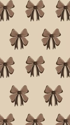 a brown bow on a beige background is featured in this seamless wallpaper pattern