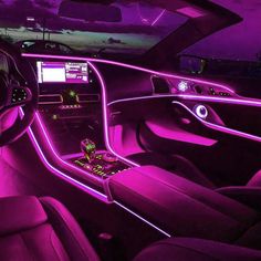 the interior of a car with purple lighting