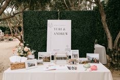 a table topped with pictures and photos next to trees