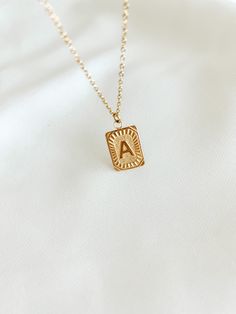 Experience the luxury of our 18k gold-plated stainless steel Initial Necklace! Free of lead and nickel, with a 16-inch chain and a 4-inch extender, you'll be stylishly adorned for any occasion. Vintage Initial Necklace, Trendy Personalized Chain Necklace For Gift, Trendy Tarnish Resistant Gold Jewelry, Trendy Metal Jewelry With Square Pendant, Trendy Gold Chain Necklace With Round Pendant, Gold Metal Initial Pendant Necklace, Gold Metal Pendant Initial Necklace, Minimalist Metal Jewelry With Initial Pendant, Square Pendant Initial Necklace Gift