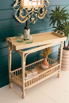 a table with a mirror on it next to a potted plant