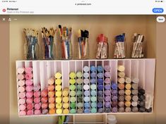 a shelf filled with lots of different colored paints